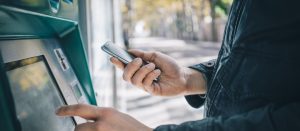 Closeup,Of,Male,Hands,Using,Smart,Phone,While,Typing,On