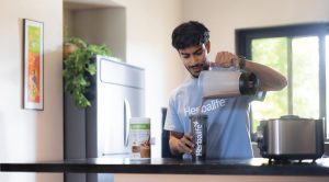 Man Preparing Protein Shake in Modern Kitchen